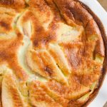 Pear Clafouti in a white baking dish on a wooden table