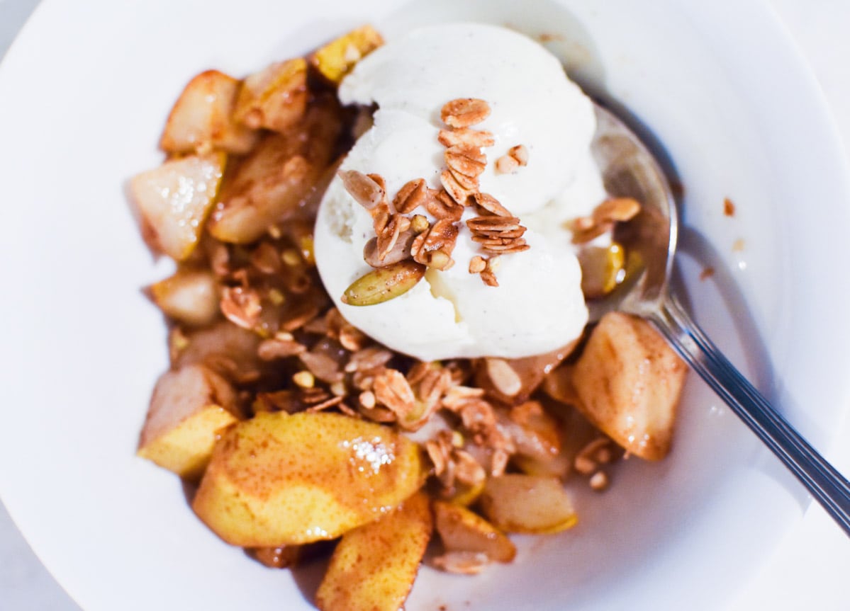 A bowl of pears and ice cream with buckwheat granola