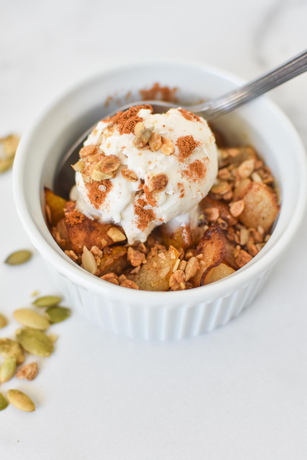 A pear crumble topped with an oat crust on a white table