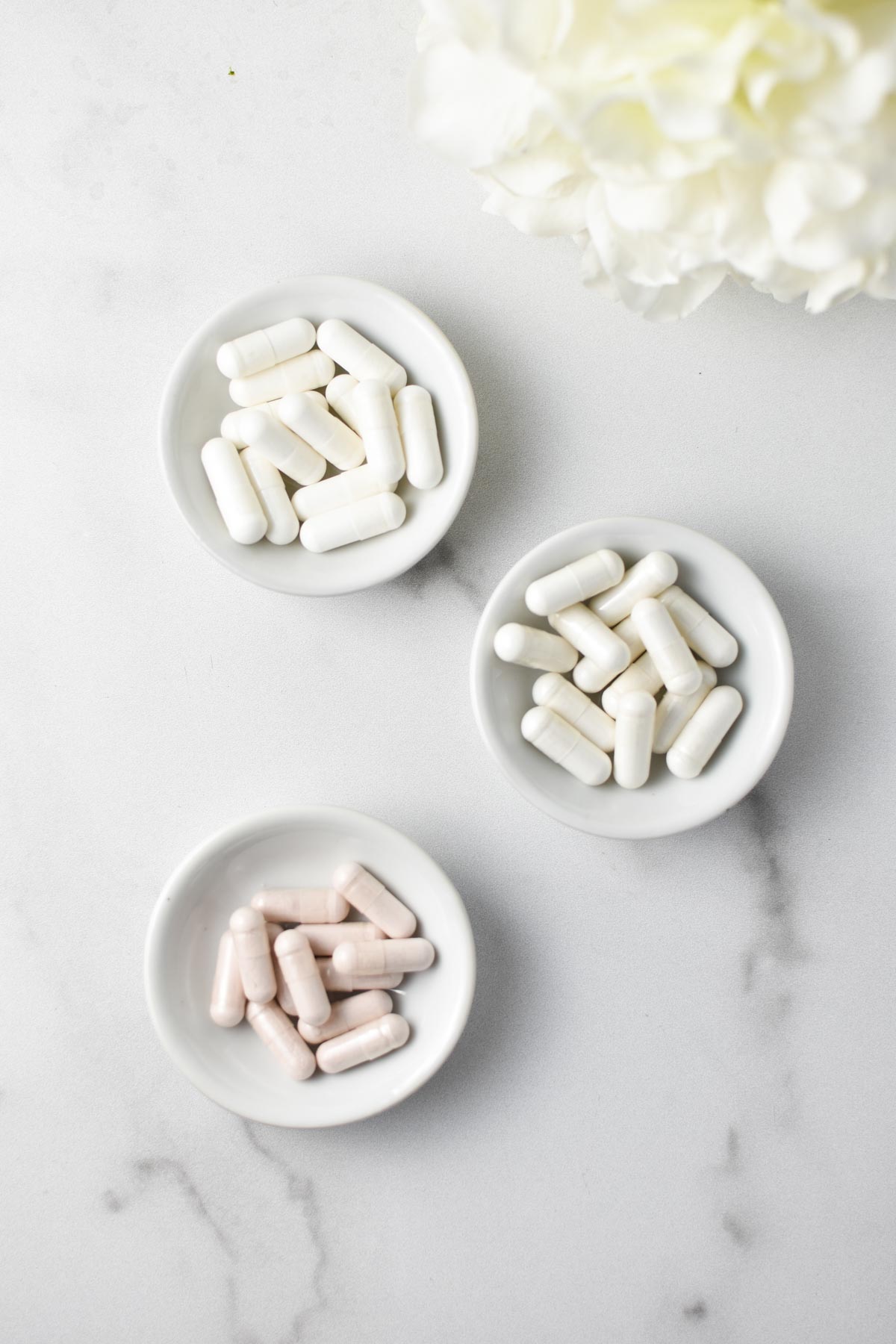 Three cups filled with 3 different types of magnesium supplements.