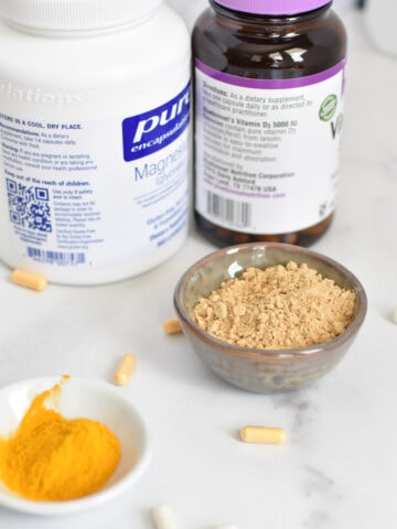 Magnesium, ginger, turmeric, and riboflavin on a white table