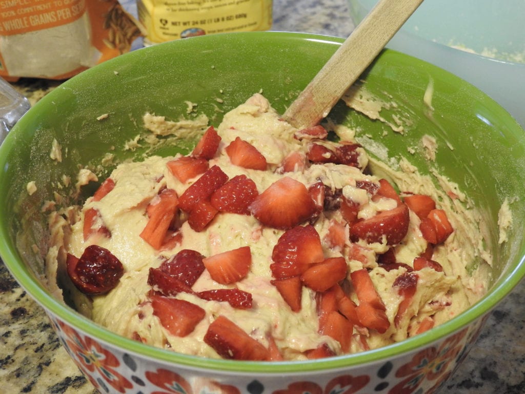 Mixing strawberries into the batter