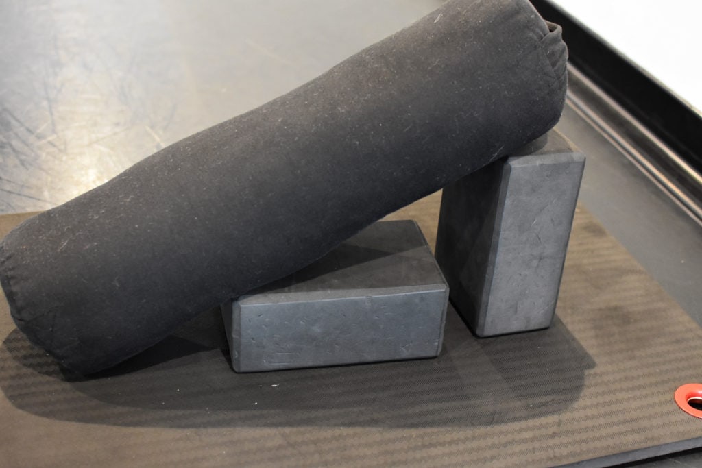 Two blocks and a bolster on a yoga mat