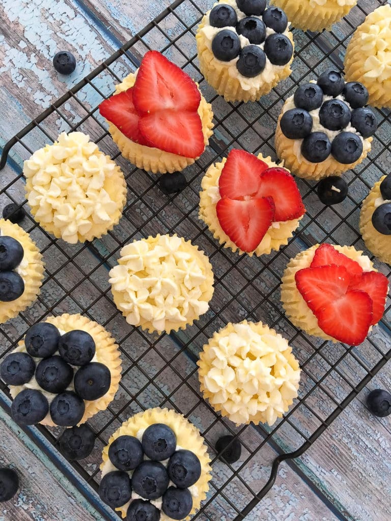 Crustless cheesecake bites on a cooking rack with different fruits on top