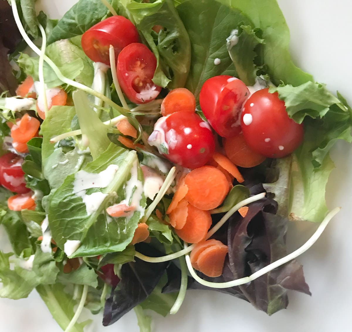 A green salad tossed in ranch dressing. 