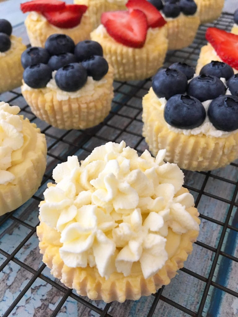 A close up of a plain frosted cheesecake bite