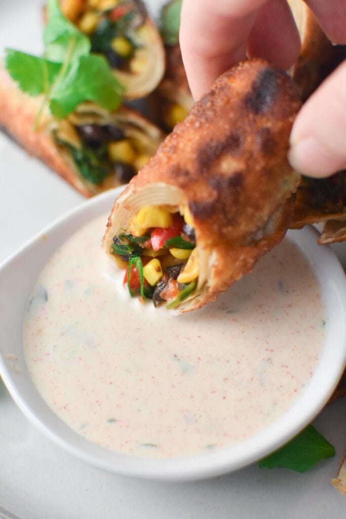 Dipping a Southwest Egg Roll into ranch dressing.