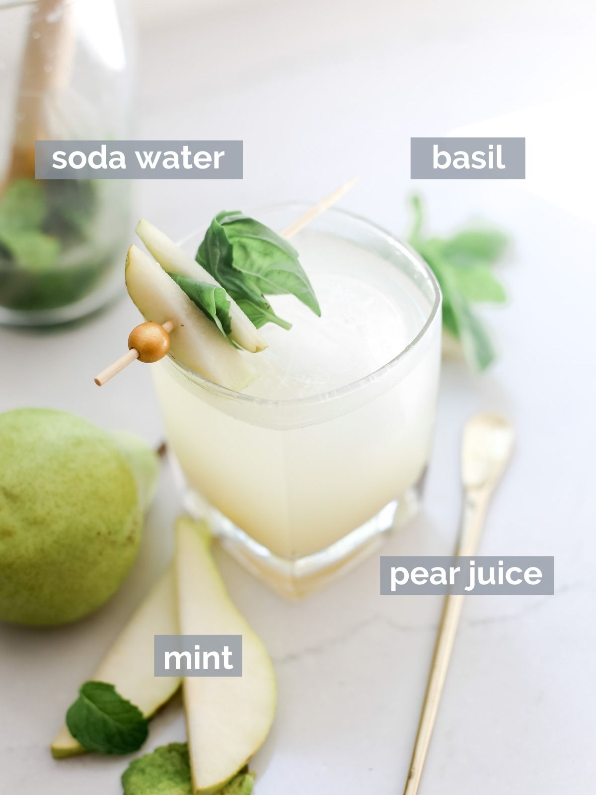 Pear juice, mint, basil, ice, and pears on a white table