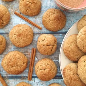 Snickerdoodles on a wood board with cinnamon sticks