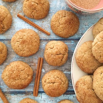 Snickerdoodles on a wood board with cinnamon sticks