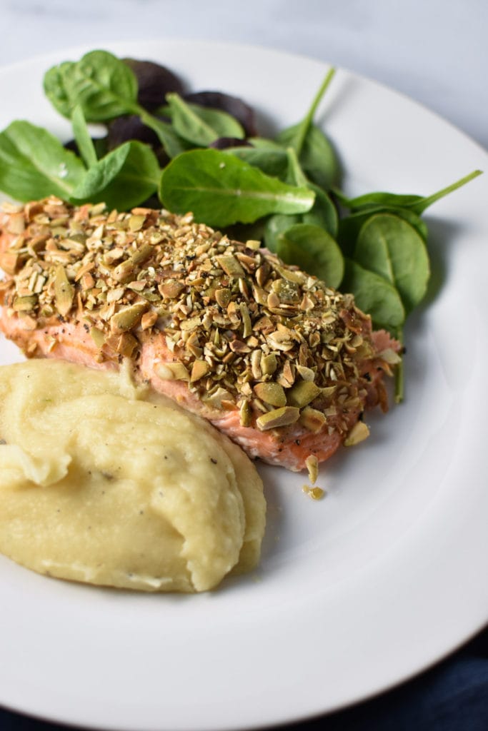 This recipe for pepita crusted salmon is nut free, dairy free, low carb, whole 30, and super easy to make. Roasted on one pan, it's perfect for a weeknight dinner that's Heal Your Headache HYH migraine diet safe. #salmon #dinner #whole30 #paleo #migrainediet