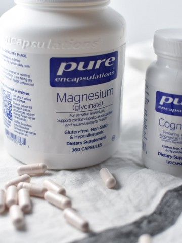 Two bottles of magnesium with supplements on the table