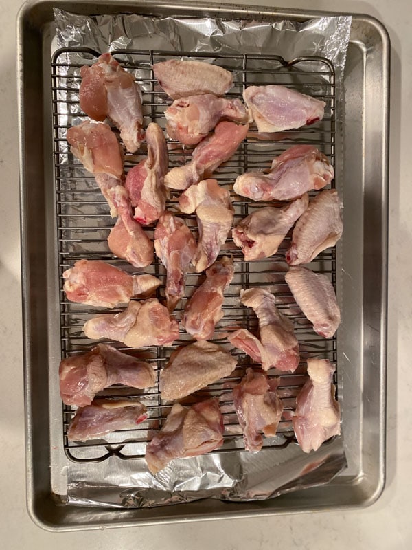 Uncooked wing pieces on a baking sheet