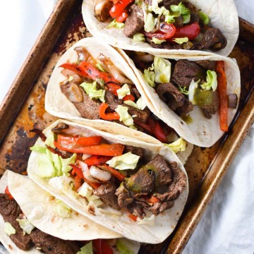 Quick and easy steak fajita recipe, perfect for a Friday night dinner. These flank steak fajitas are marinated in fresh (migraine safe) spices and cherry juice, which gives it the tart flavor without citrus. #fajitas #steak #migrainediet