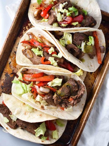 Quick and easy steak fajita recipe, perfect for a Friday night dinner. These flank steak fajitas are marinated in fresh (migraine safe) spices and cherry juice, which gives it the tart flavor without citrus. #fajitas #steak #migrainediet #recipe
