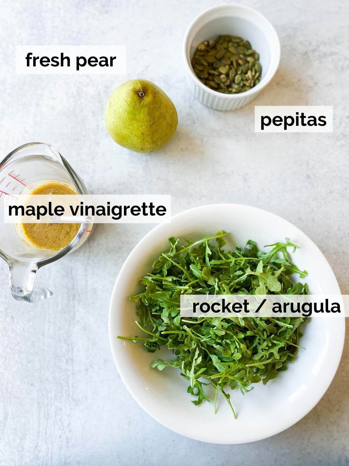 Pear and rocket ingredients on a table.