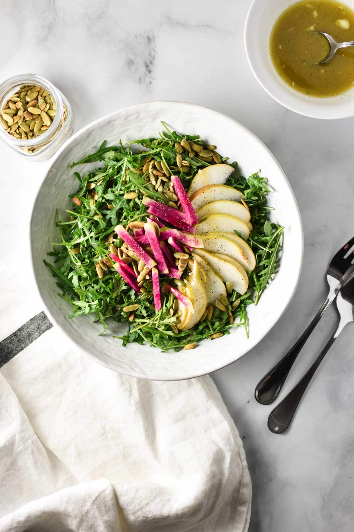 Rocket salad topped with pears and radish.