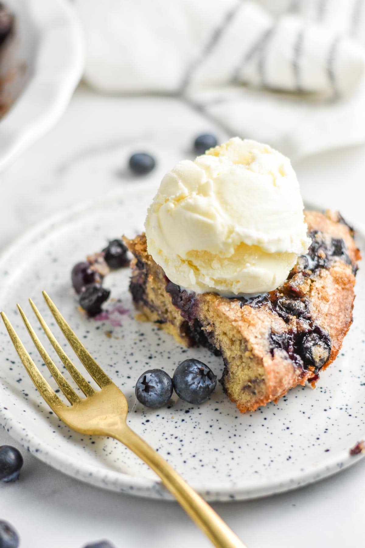 A slice of an impossible blueberry pie on a plate.