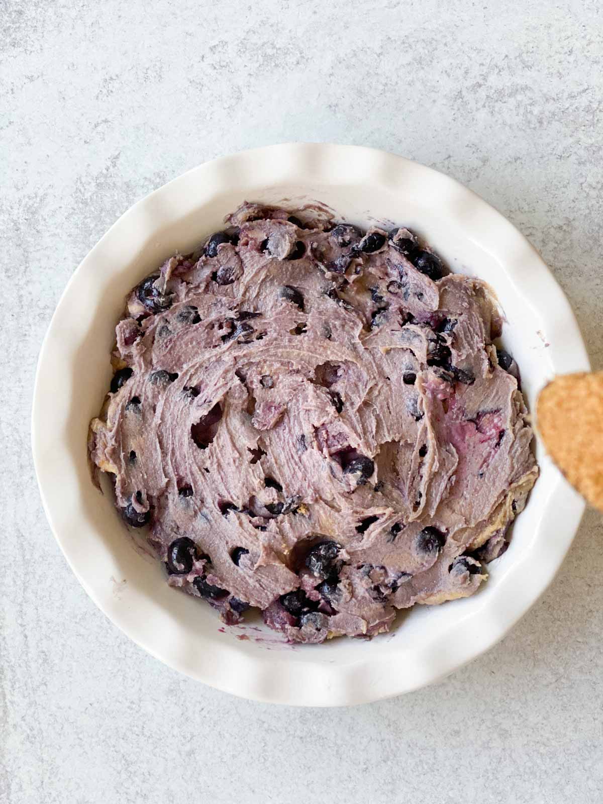 Blueberry pie in a dish before baking.