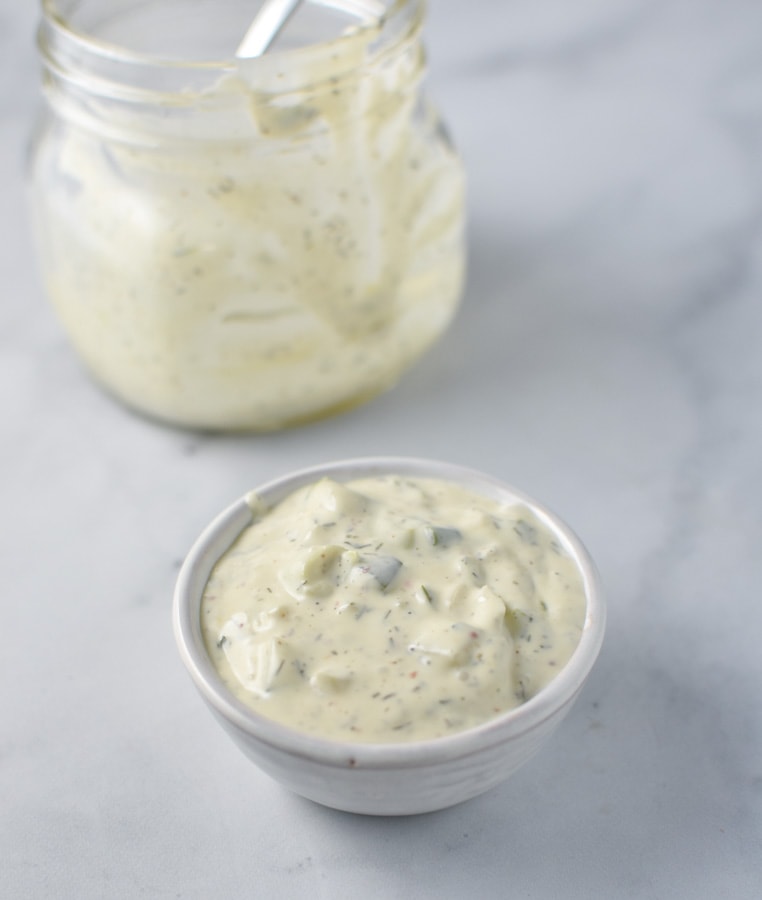 A mixture of mayo, cucumbers, dill, and capers for homemade whole30 tartar sauce in a bowl