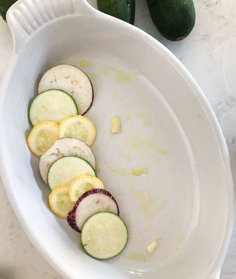 Layered squash and eggplant slices in a baking dish