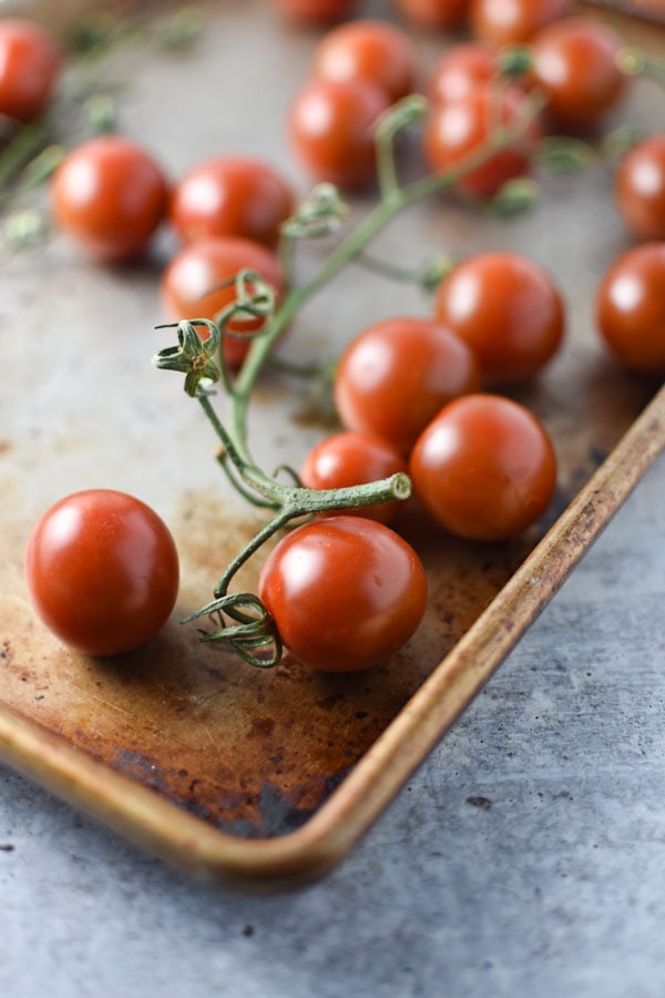 cherry tomatoes on the vine on a sheet pan