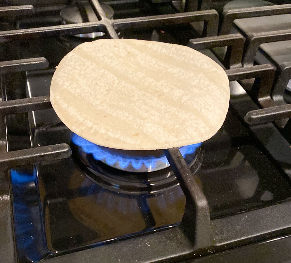 Cooking a tortilla on a gas grill. 