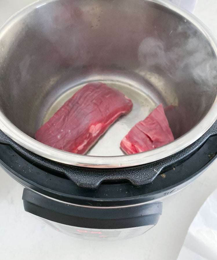 Flank steak searing in an instant pot.