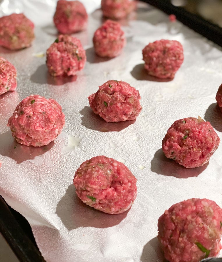 meatballs rolled on a greased pan with tin foil