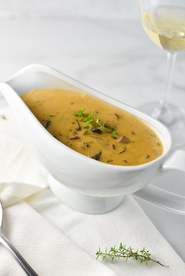 gravy in a white gravy boat on a marble table