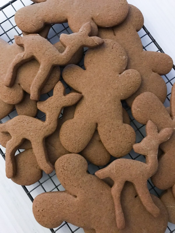 Baked classic gingerbread cookies stacked on a wire rack