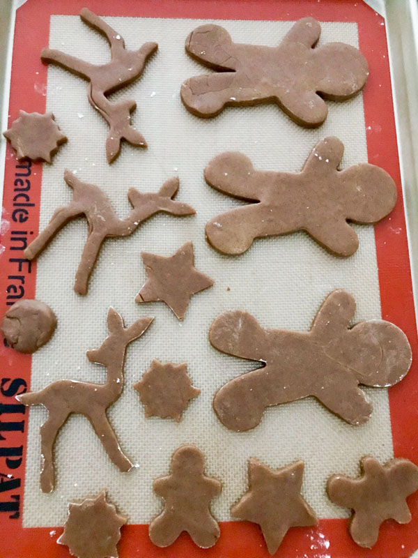 Unbaked gingerbread cookies on a silpat mat