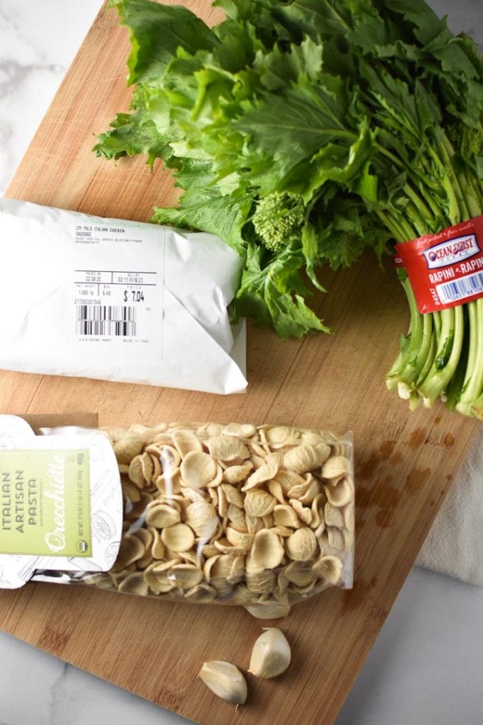 Orecchiette, rapini, and sausage on a cutting board