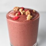 Cherry smoothie topped with mulberries and goji berries