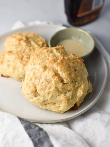 Two drop biscuits next to maple cream