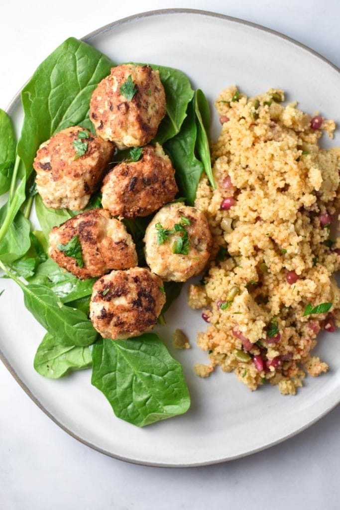 Chicken meatballs on a plate with couscous.