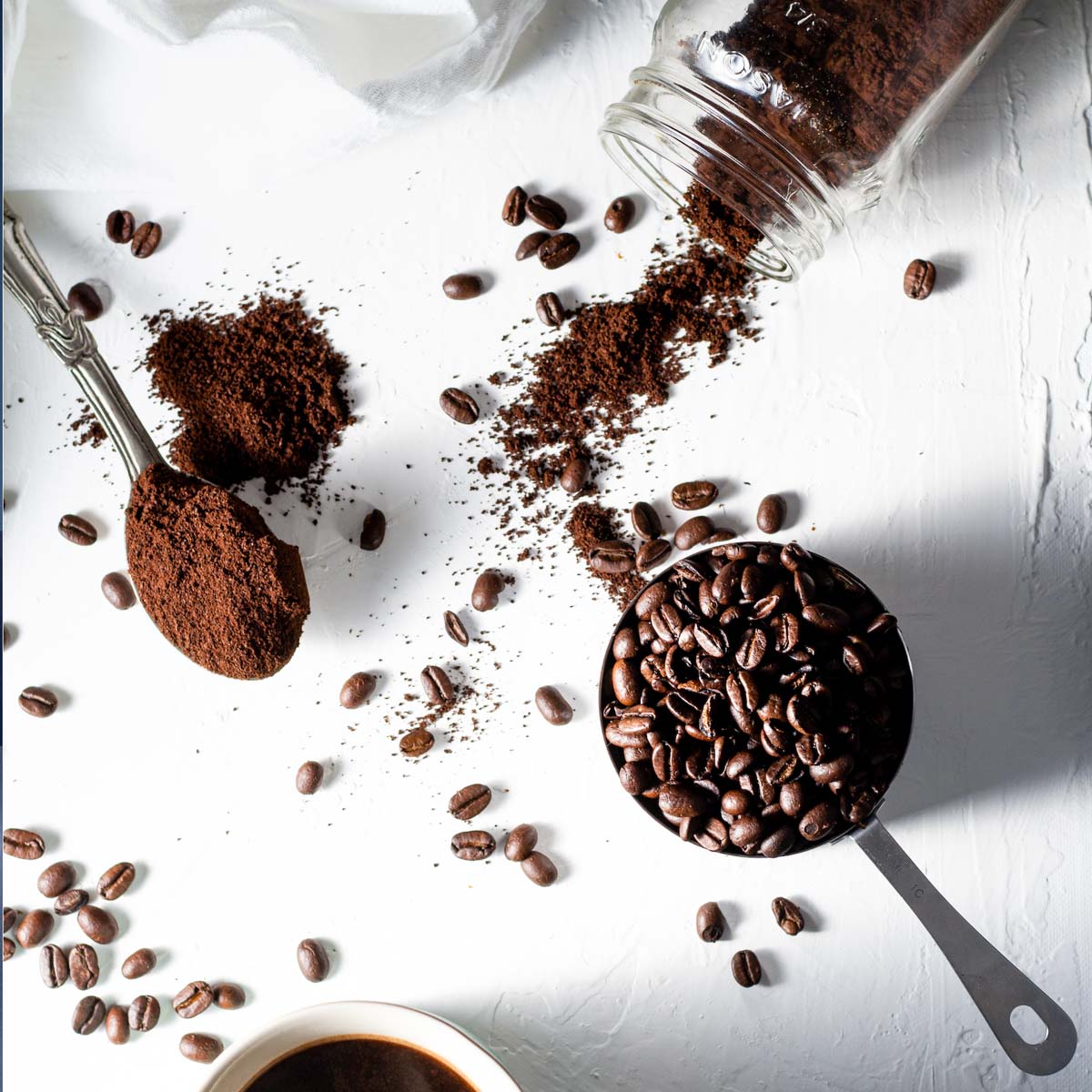 Coffee, chocolate, and cocoa spilled on a white table