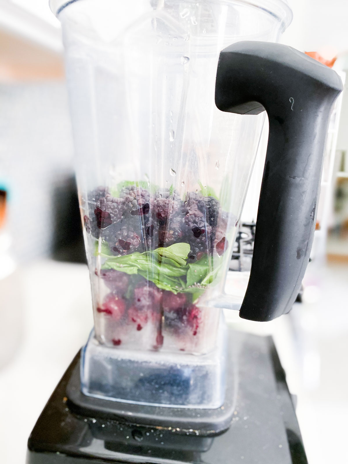 Blackberry smoothie ingredients in a blender. 