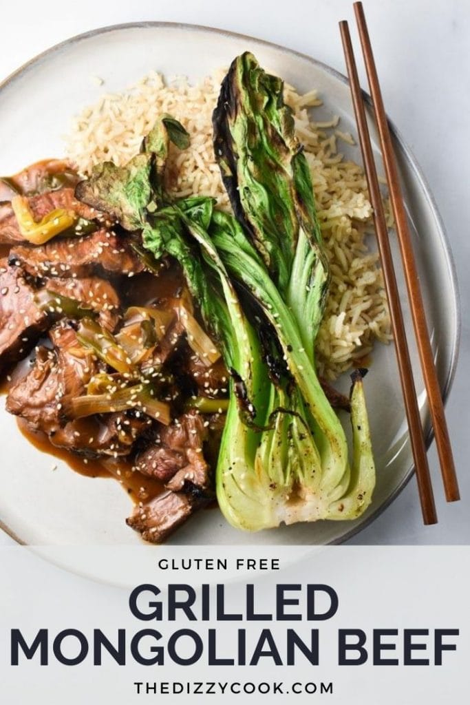 Grilled mongolian beef on a plate with bok choy and rice