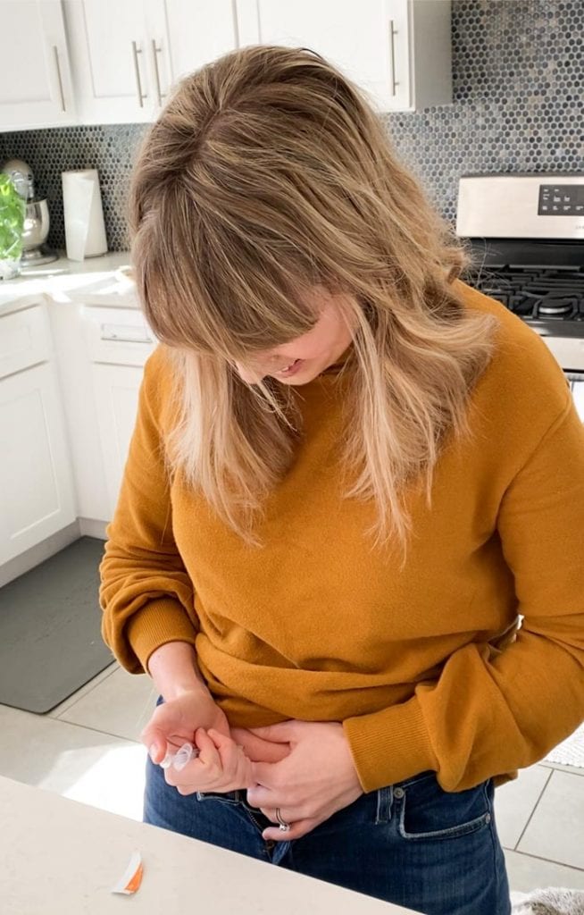 A woman giving herself an IVF injection