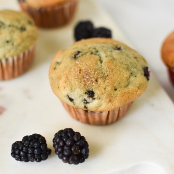 Blackberry cream cheese muffins on a marble serving dish