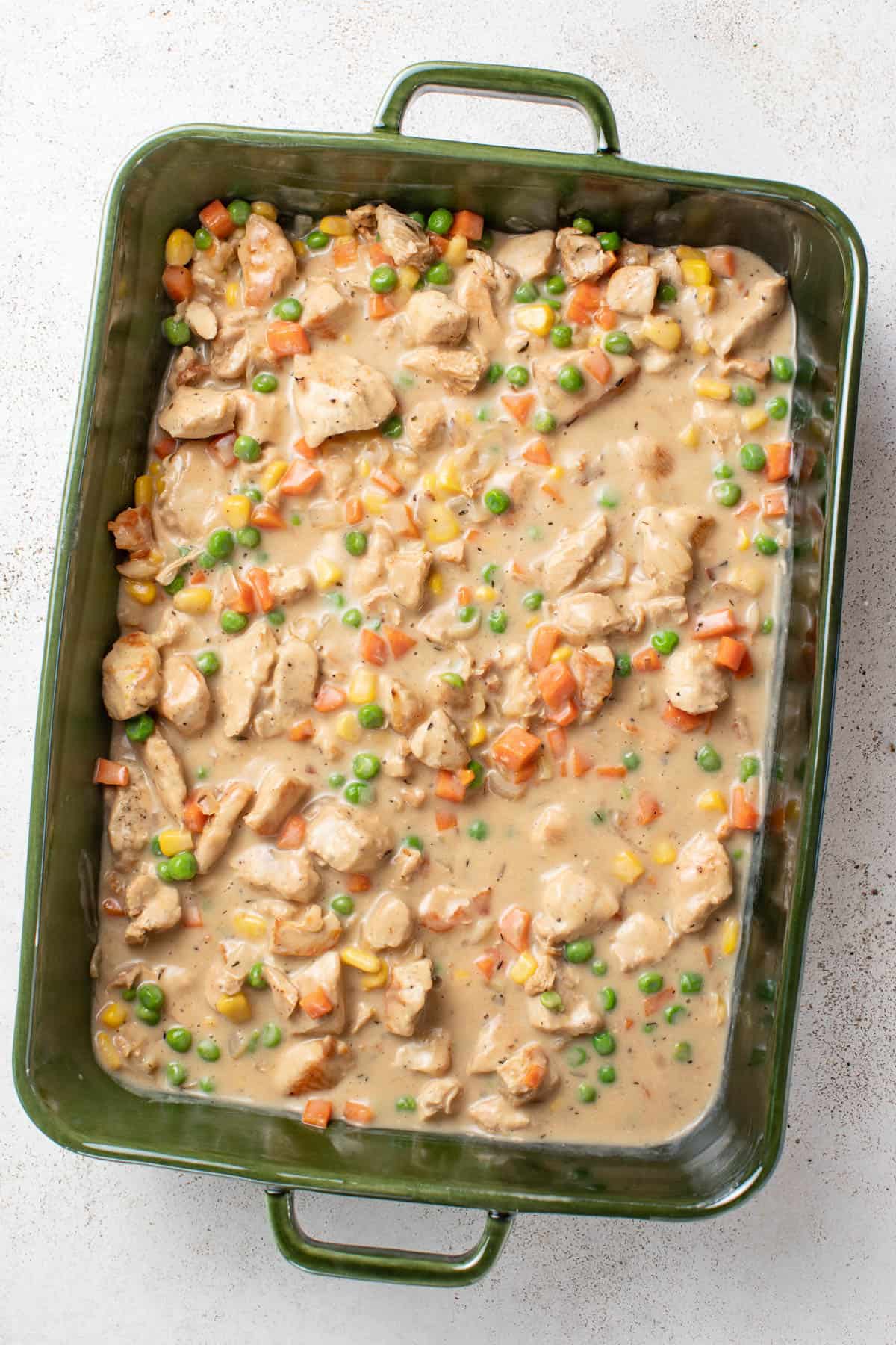 Crustless chicken pot pie in a green baking dish.