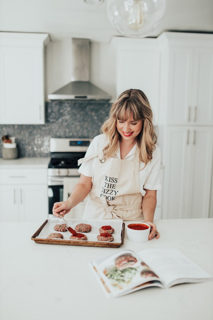 A girl in a Dizzy Cook apron cooking meatloaf