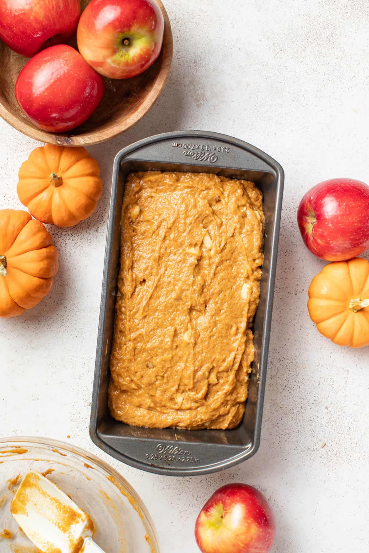 Pumpkin apple batter in a loaf pan before baking.