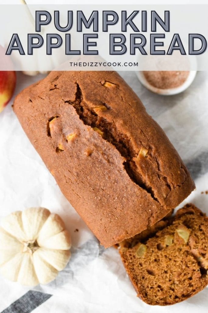 A loaf of pumpkin apple bread that's been sliced with pumpkins and cinnamon sugar