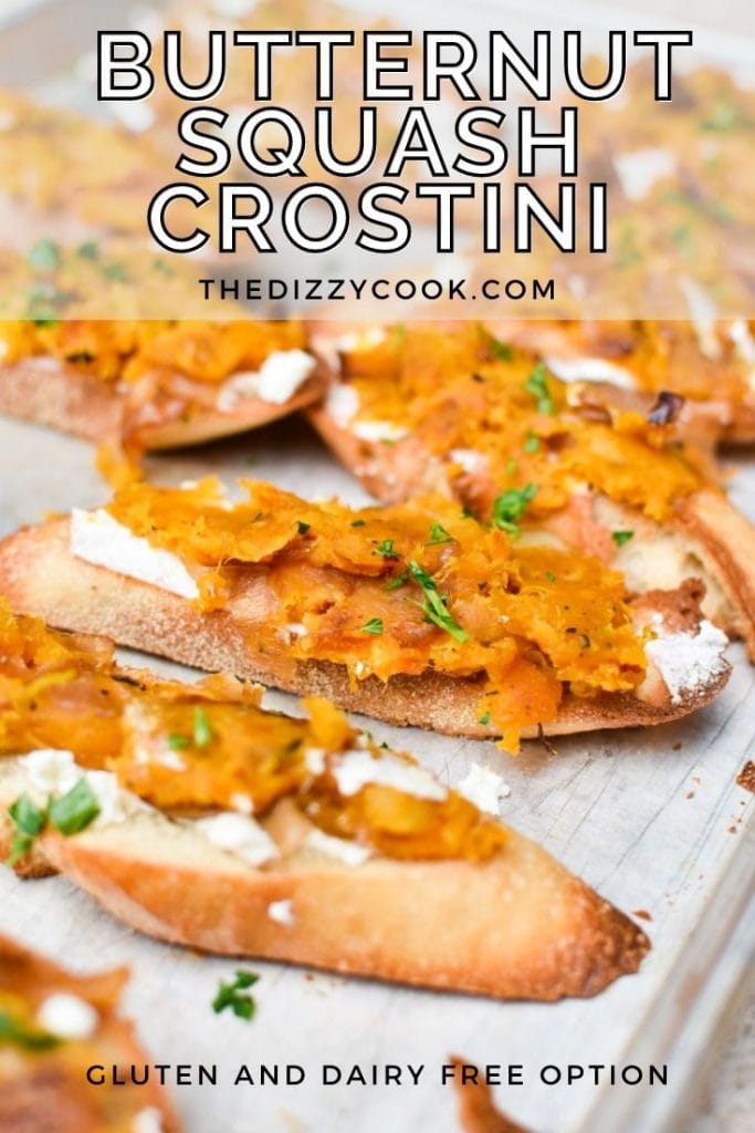 Butternut squash crostini lined up on a sheet pan, topped with ricotta and sprinkled with mint
