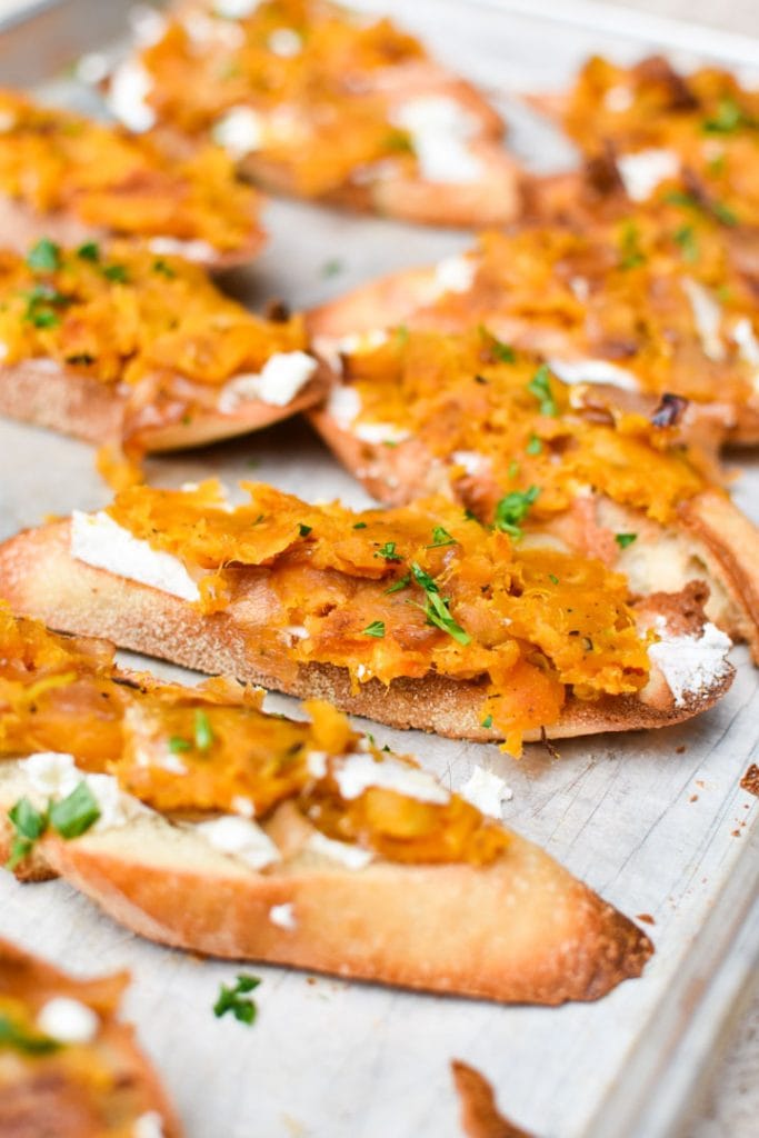 Crostini topped with butternut squash mash and ricotta cheese.