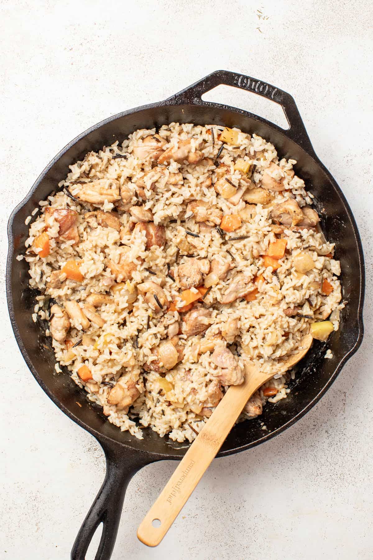 Stirring the wild rice into the chicken and dijon sauce.