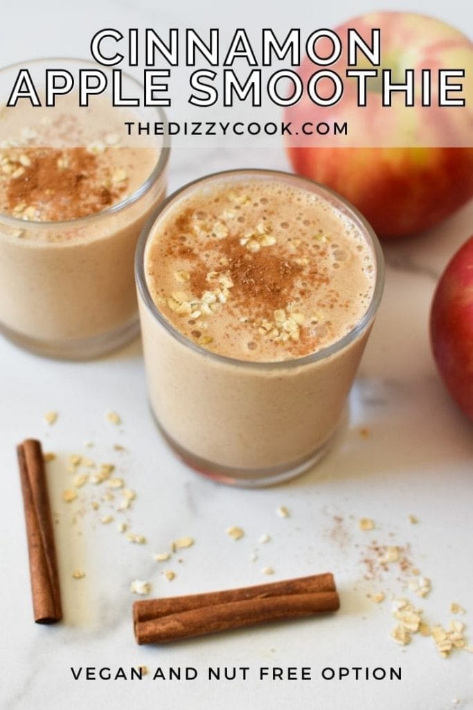 Two apple smoothies dusted with cinnamon and oats on a marble table
