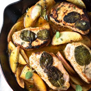Apple cider pork chops in a cast iron pan